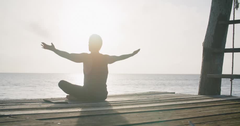 A person doing stretches and meditating outdoors