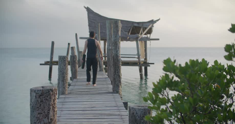 A man walks down the pier