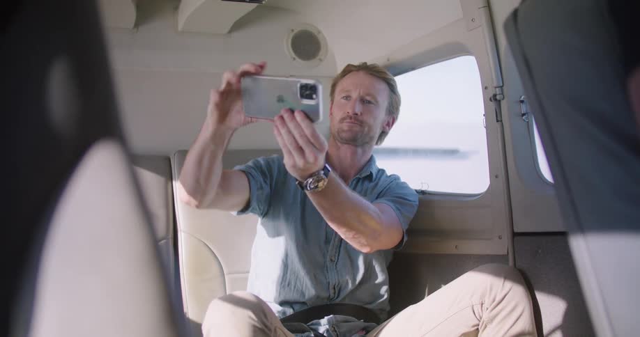Person taking selfie on plane