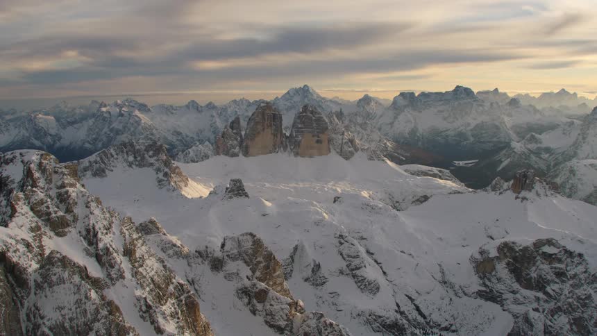 An aerial view of a mountain range covered in snow