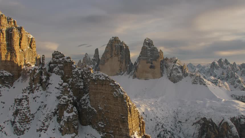 An aerial view of mountains with snow on them