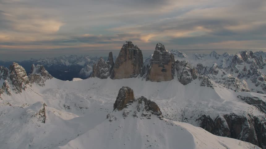 Thick clouds cover a snowy mountain range