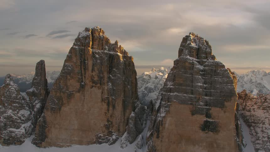 Snow covered badlands stand under overcast sky