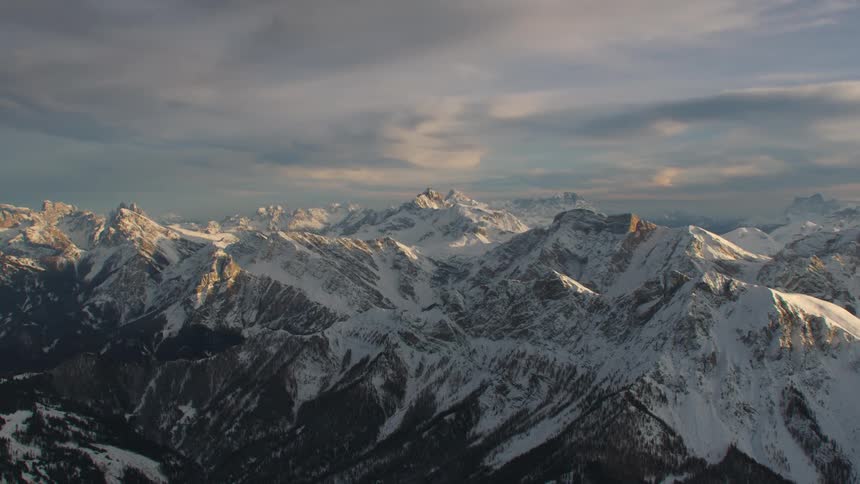 An aerial view of a mountain range covered in snow