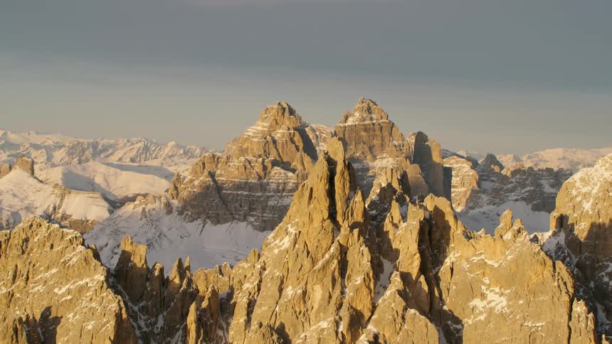 Jagged peaks are poking out of snow covered mountain wilderness