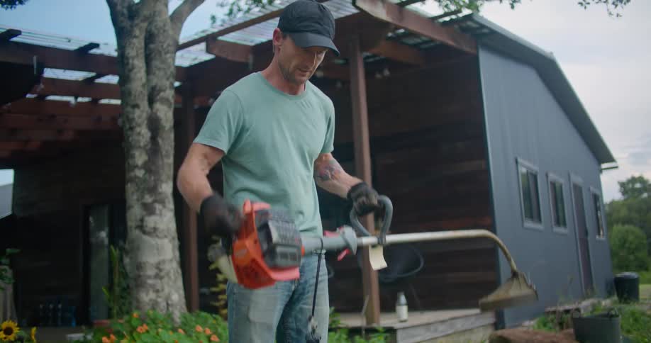 A man trying to start a weed wacker