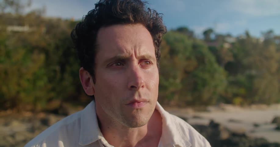 A man standing outdoors looking sad