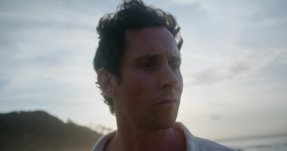 A man thinking while standing out on the beach