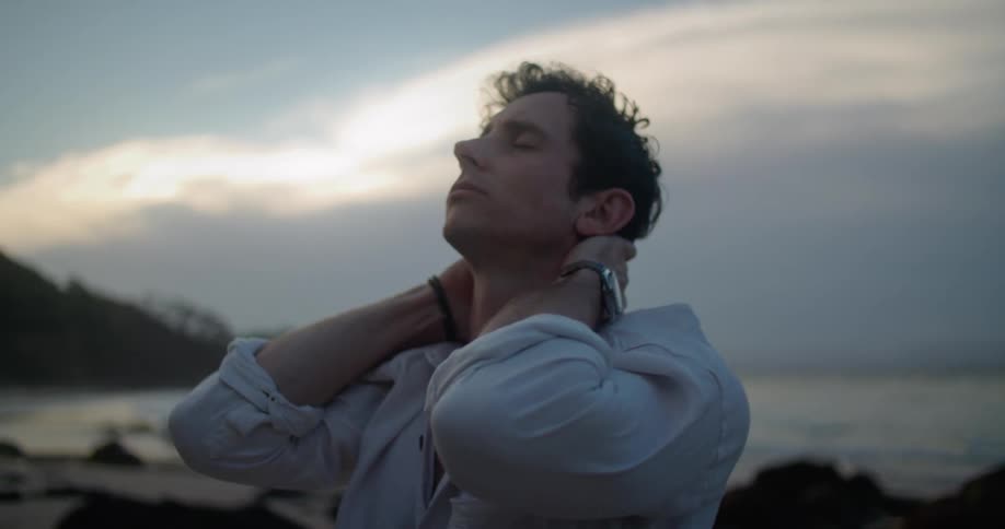 A man thinking while standing around outdoors