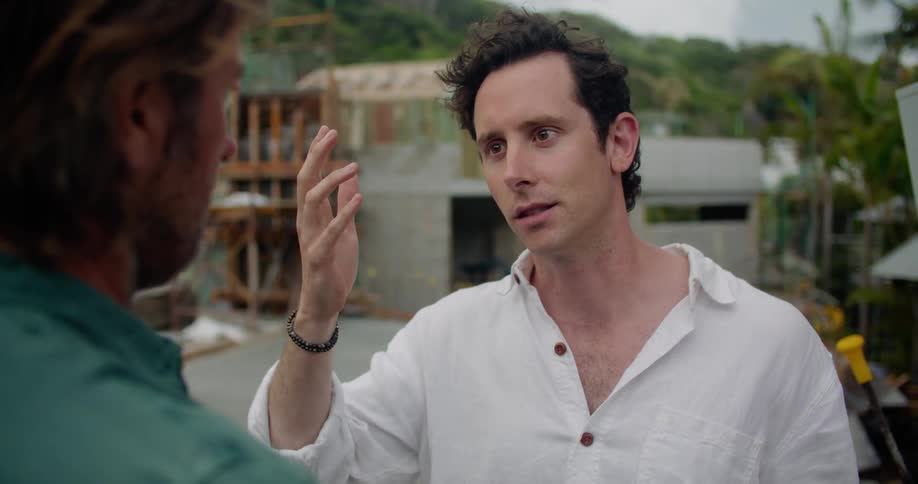 Two men talking to each other outdoors