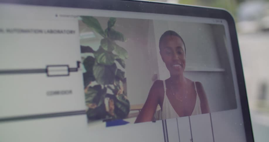 A woman waves on the computer display