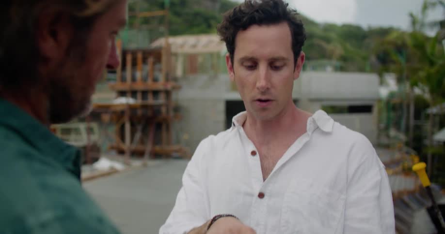 Two men communicate by the work site