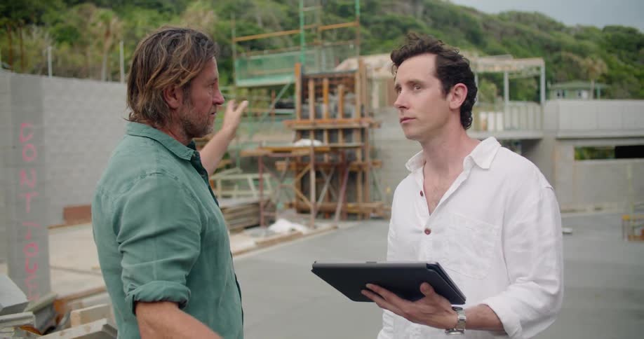 Two workers talking at a construction site