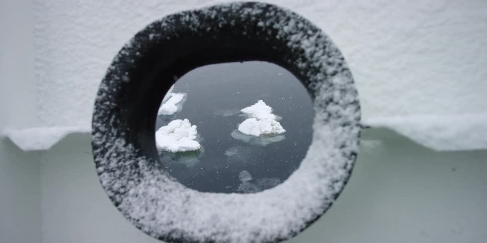 Looking through a window of a ship of ice floating below
