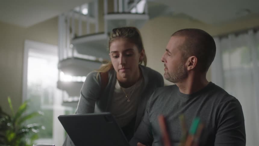Daughter helps parent with computer before leaving