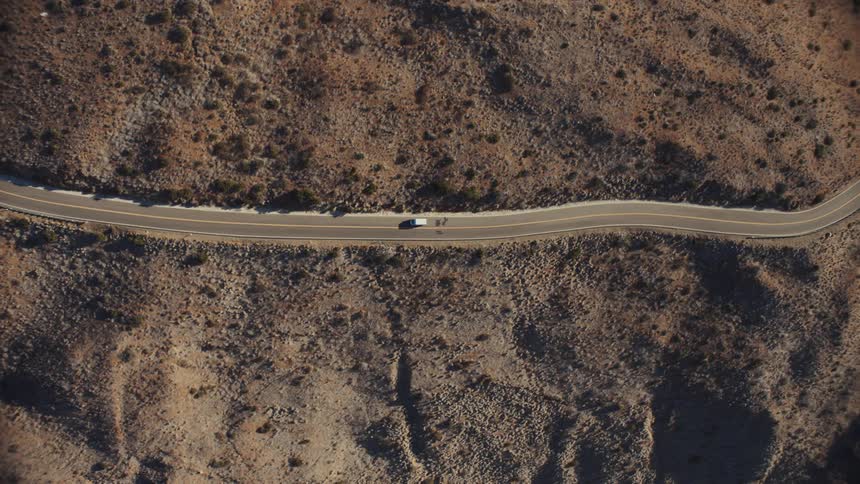 Aerial view of a van traveling on an open road