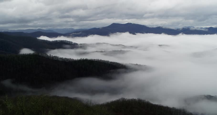 An aerial view of some hills with trees on them