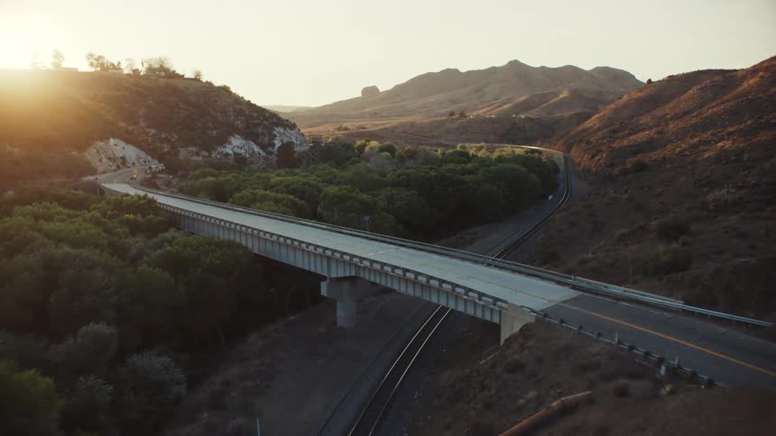 A bridge runs over the train tracks