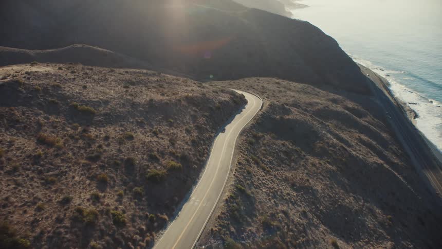 A coastal road winding on mountain overlooking the ocean