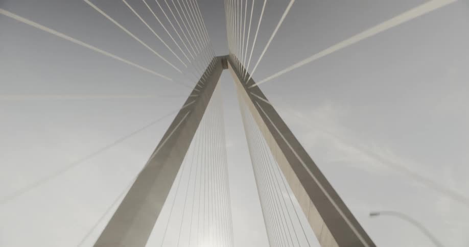 The sun is shining on cables holding a suspension bridge