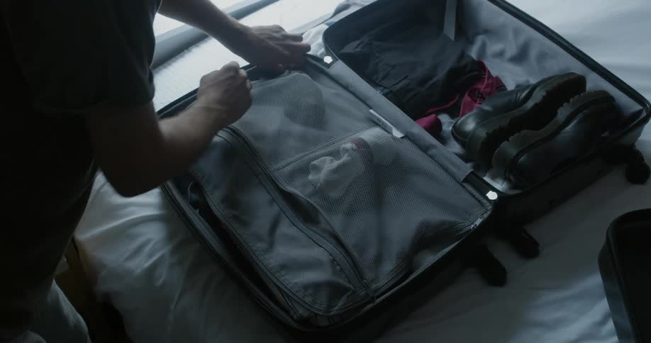 Person packing suitcase