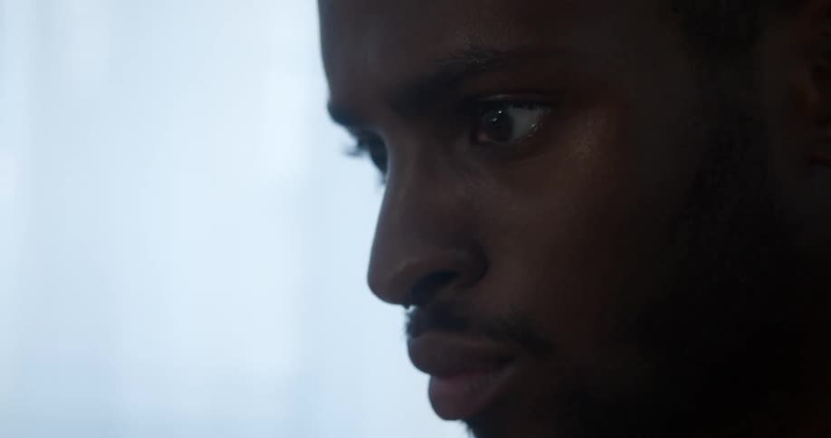 A man stares forward blinking