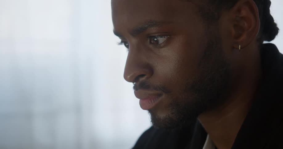 A man is looking at something and blinking