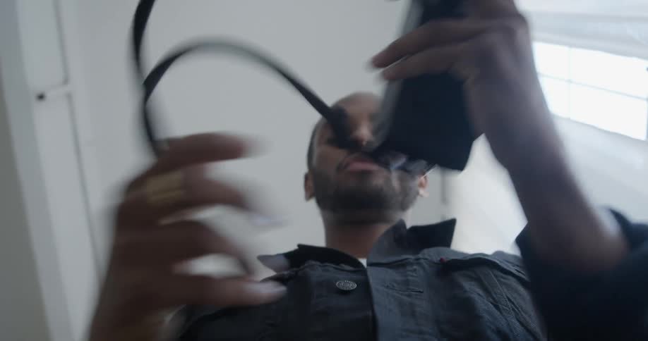 A man looks in his camera then puts it down