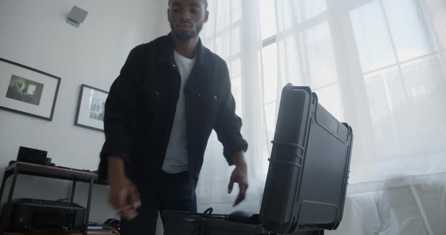 Photographer packs camera in suitcase before walking away