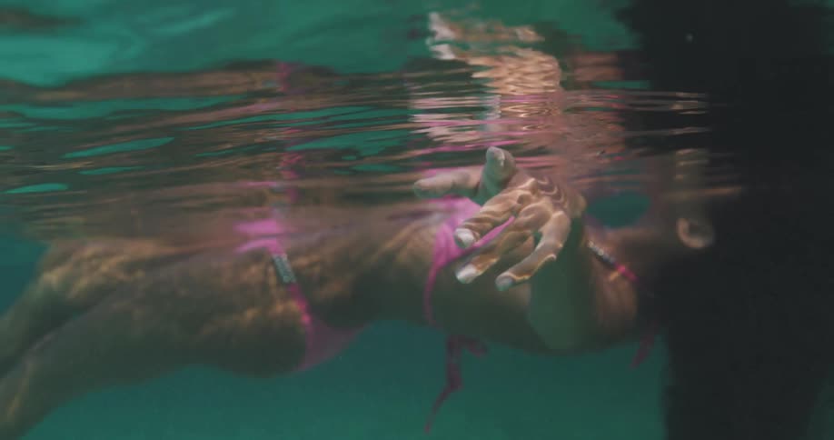 A woman is floating in the pool