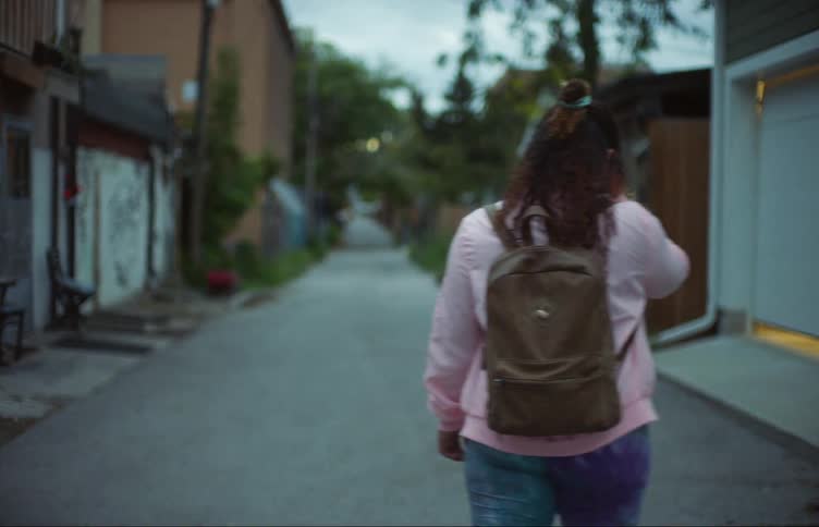 A person walking down the alley makes a turn