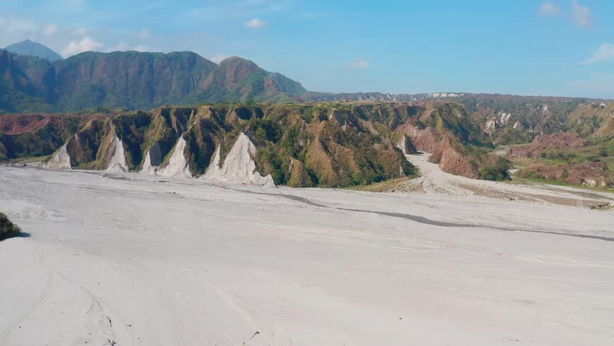 An aerial view of some hills next to a beach