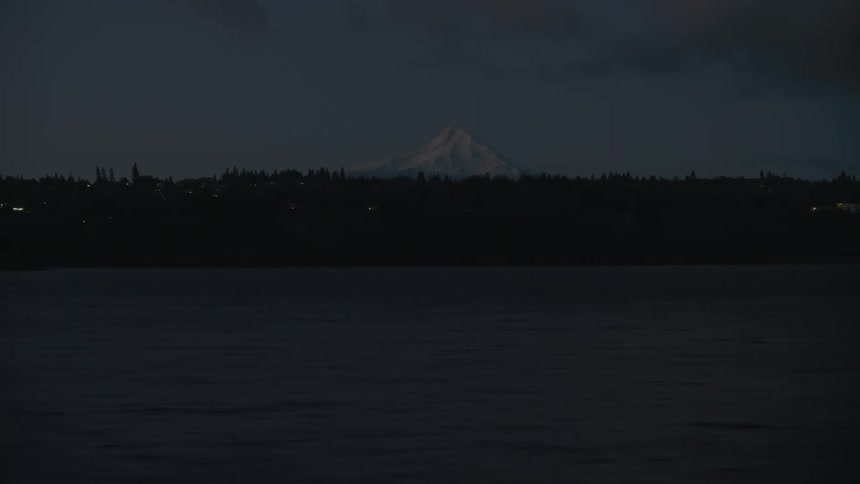 Blue hour early morning pre sunrise shot of the Columbia River and Mount Hood far off on the horizon