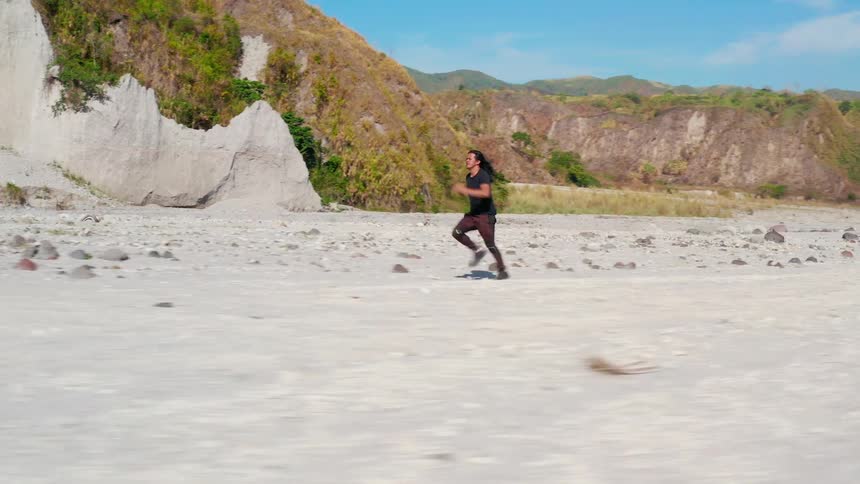 A man is running fast in the desert