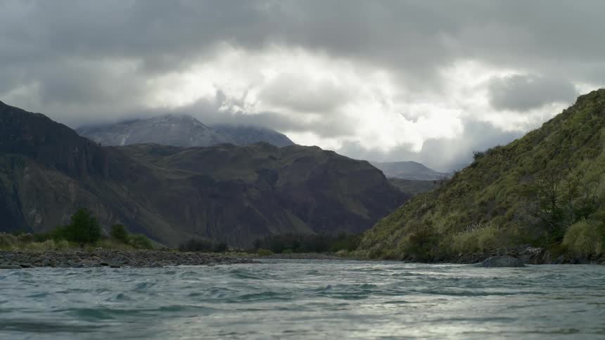 Hand held shot low as pristine river water flows directly at the lens