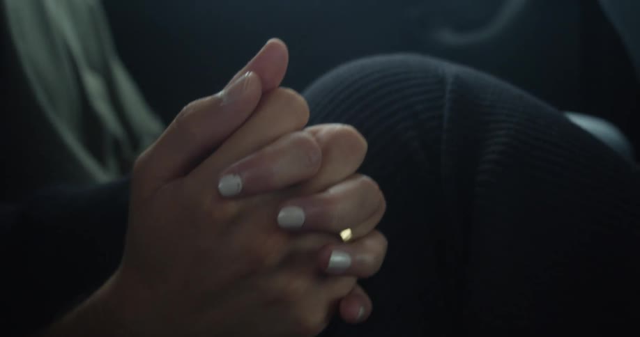 A couple riding together with hands clasped