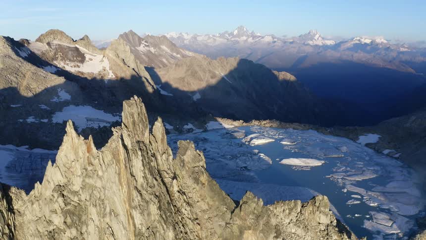 The water near the mountains is frozen over