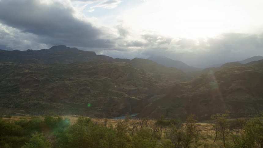 Scene setter wide shot panning right across spectacular untouched river gorge and autumn landscape
