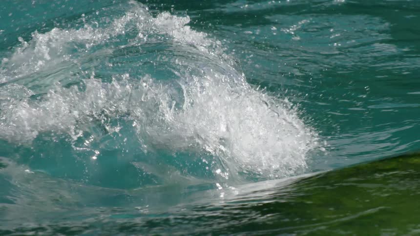 A rolling wave is splashing as it moves