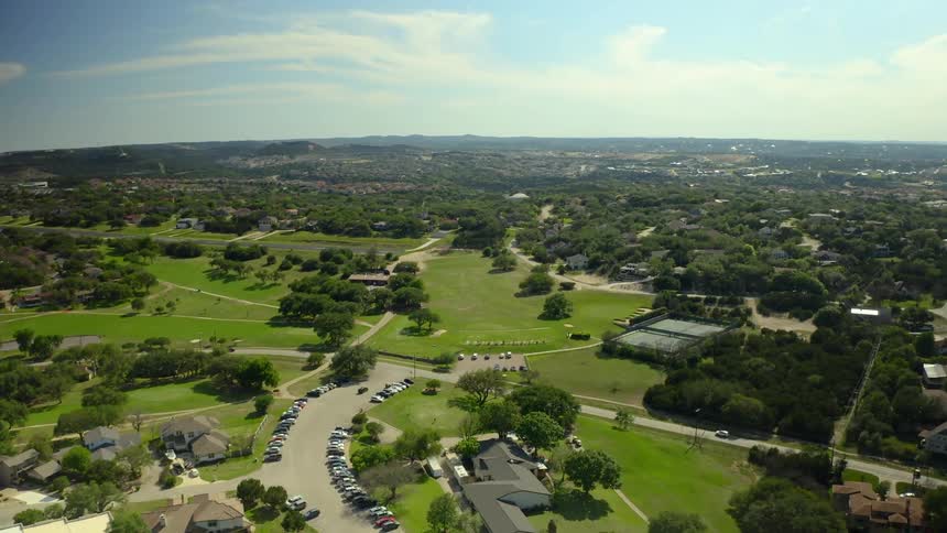 Cars move through neighborhood of large homes