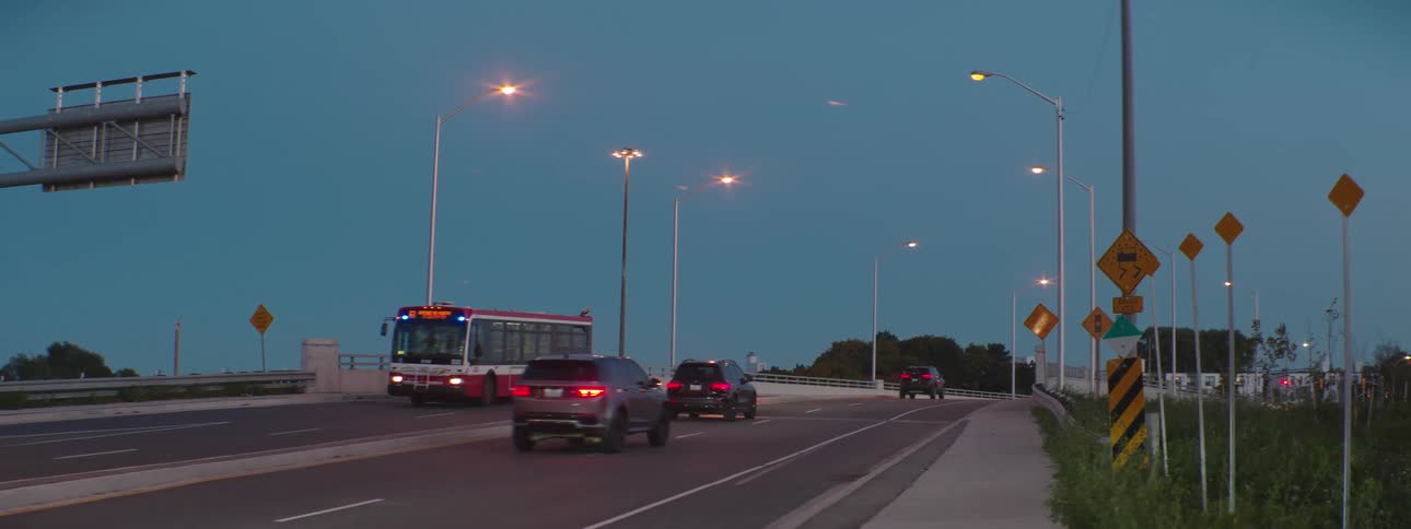 A bus travels on a highway with cars traveling in the opposite direction