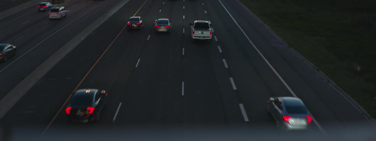 Traffic flows down multi lane divided freeway