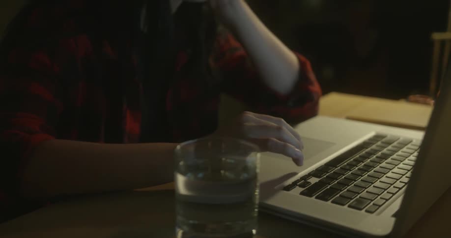 A person types on a laptop