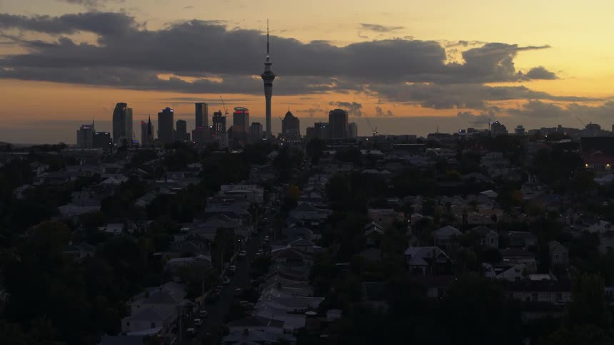 Aerial view of the skyscrapers and towers in city skyline at sunset