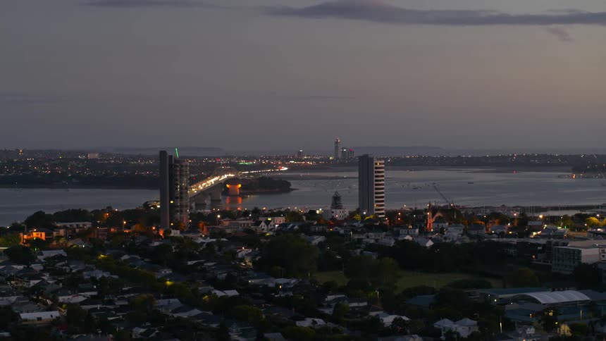 A river winding through a metropolis at sunset