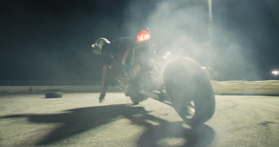 A man is doing doughnuts on his motorcycle