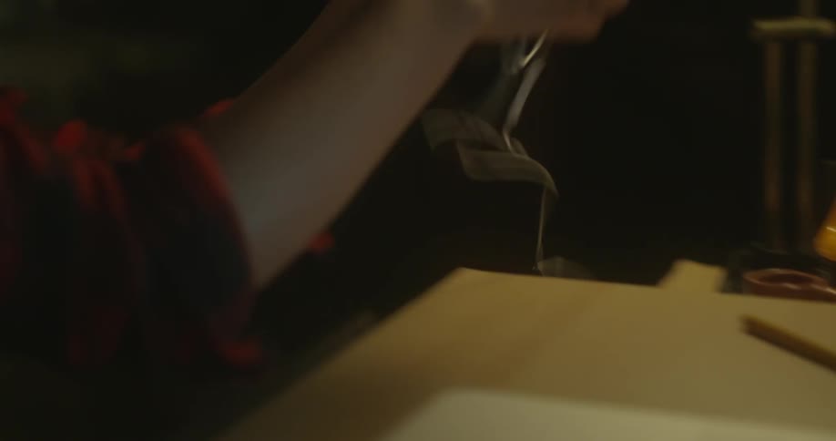 Girl sitting at a desk puts earphones in her ear
