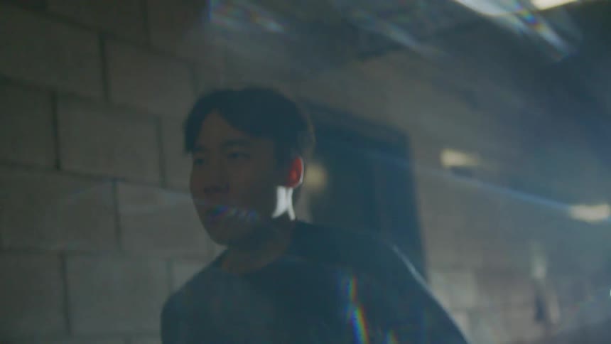 A man jogs down the dark hallway