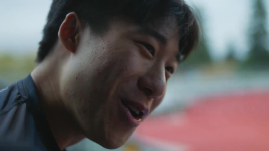 A man smiles while talking with friends