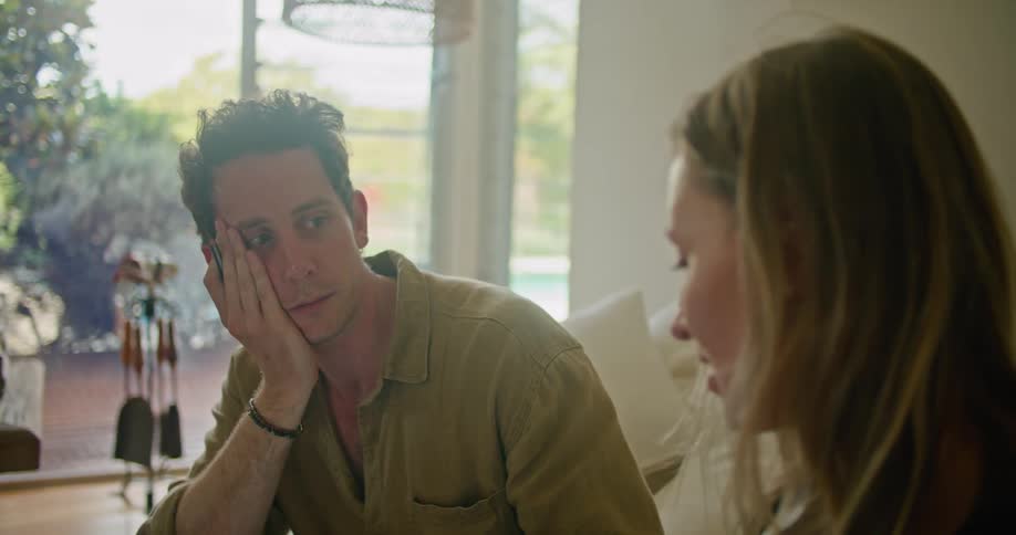 A man and woman sitting around talking together
